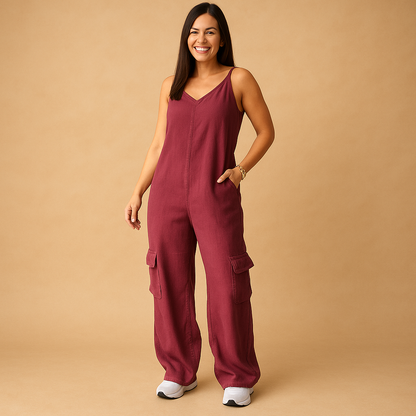 Women’s denim jumpsuit with V-neckline and open back featuring crossed straps, perfect for summer, festivals, and casual outings.