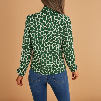 Women’s elegant polka dot blouse with bow detail and elastic cuffs, perfect for both office wear and casual outings.