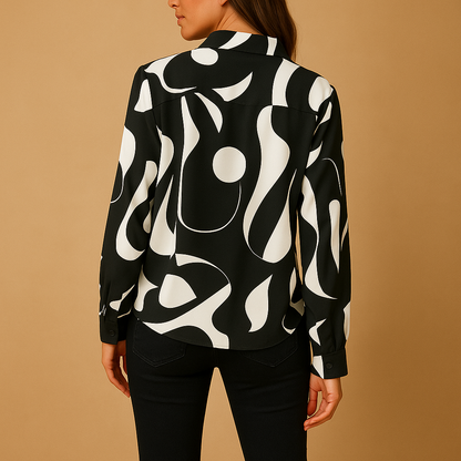 Elegant printed blouse for women in apricot and black, featuring a relaxed fit and refined, timeless design for all occasions.