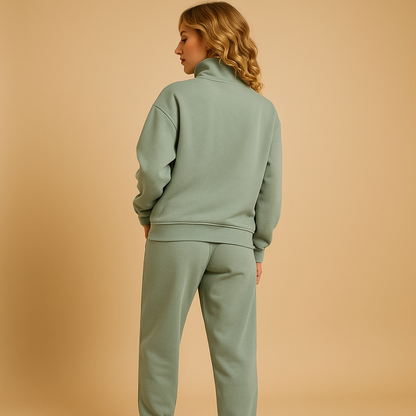 Two piece jogger set for women with relaxed-fit jogger pants and half-zip sweatshirt, available in pink, green, and blue, perfect for casual or sporty looks.